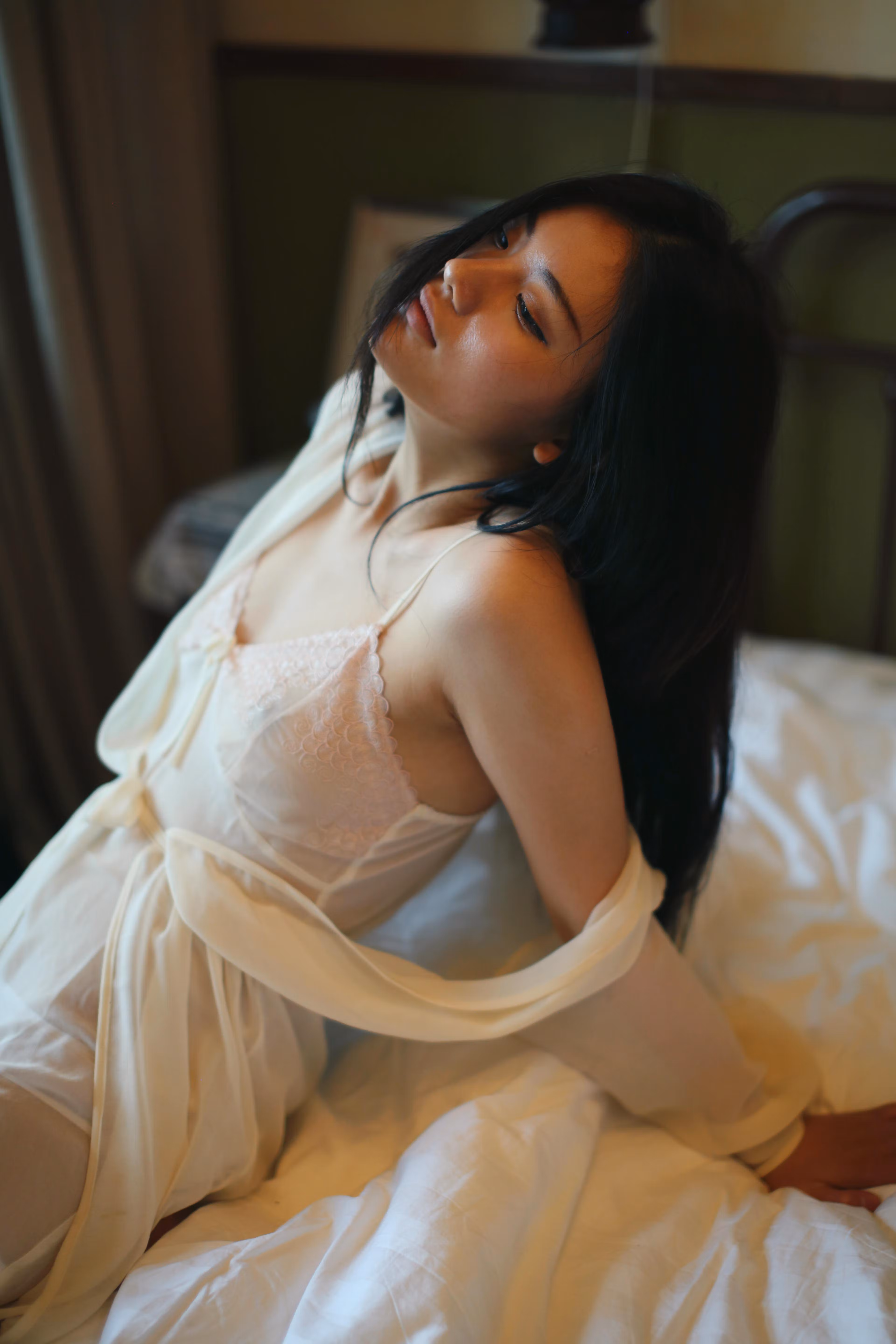 Azhu hugging knees showing slender legs and captivating gaze